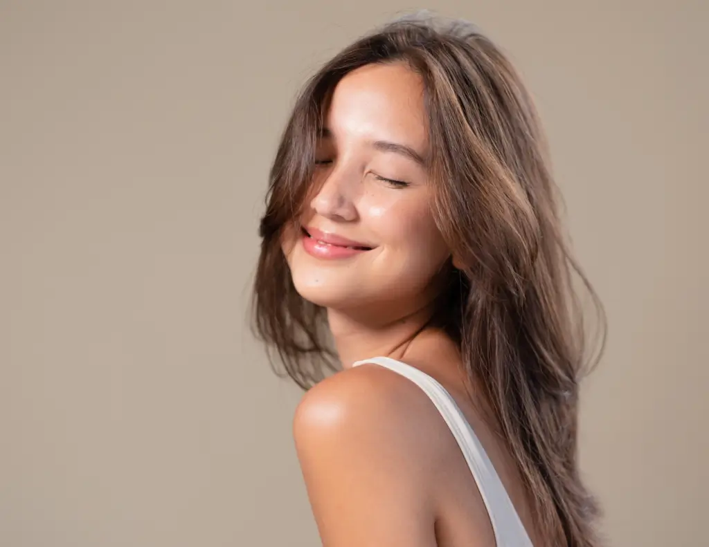 Smiling woman with long brown hair.